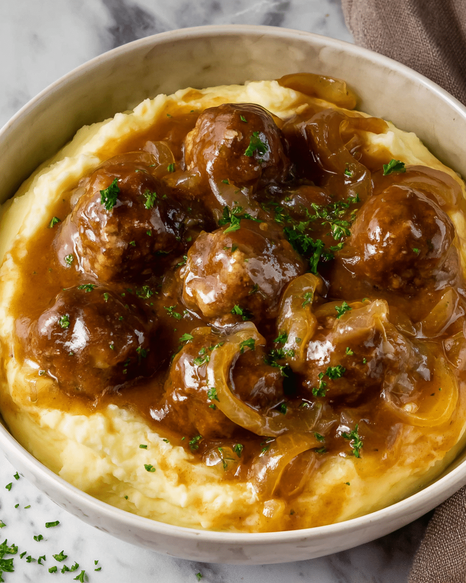 A wooden spoon holds three meatballs covered with melted white cheese and a thick brown onion sauce. The meatballs are round and glossy, while the sauce is shiny with visible soft cooked onion slices and small green herb bits sprinkled on top. In the background, more meatballs sit in the white marbled dish, all coated with the sauce and cheese, creating a rich and hearty appearance. photo taken with an iphone --ar 4:5 --v 7