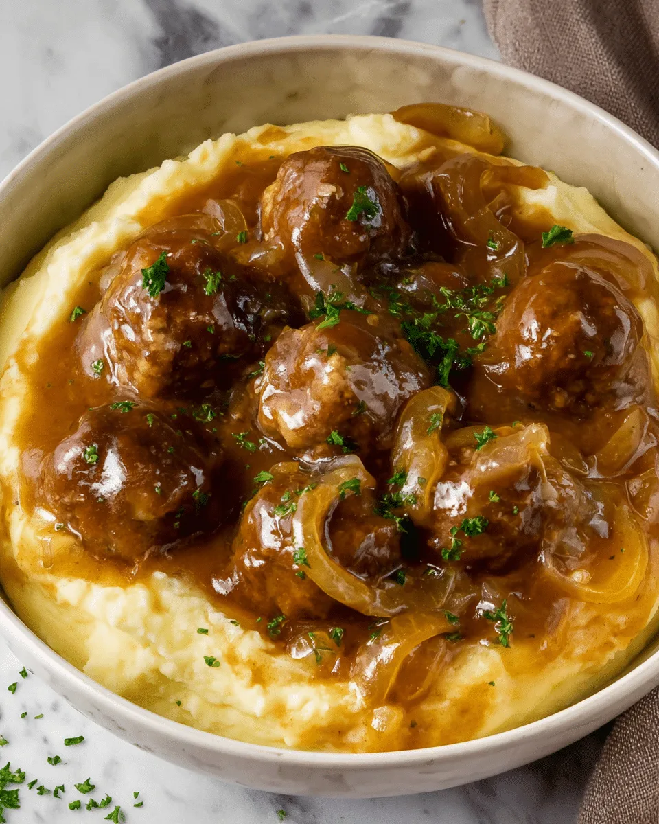 A wooden spoon holds three meatballs covered with melted white cheese and a thick brown onion sauce. The meatballs are round and glossy, while the sauce is shiny with visible soft cooked onion slices and small green herb bits sprinkled on top. In the background, more meatballs sit in the white marbled dish, all coated with the sauce and cheese, creating a rich and hearty appearance. photo taken with an iphone --ar 4:5 --v 7