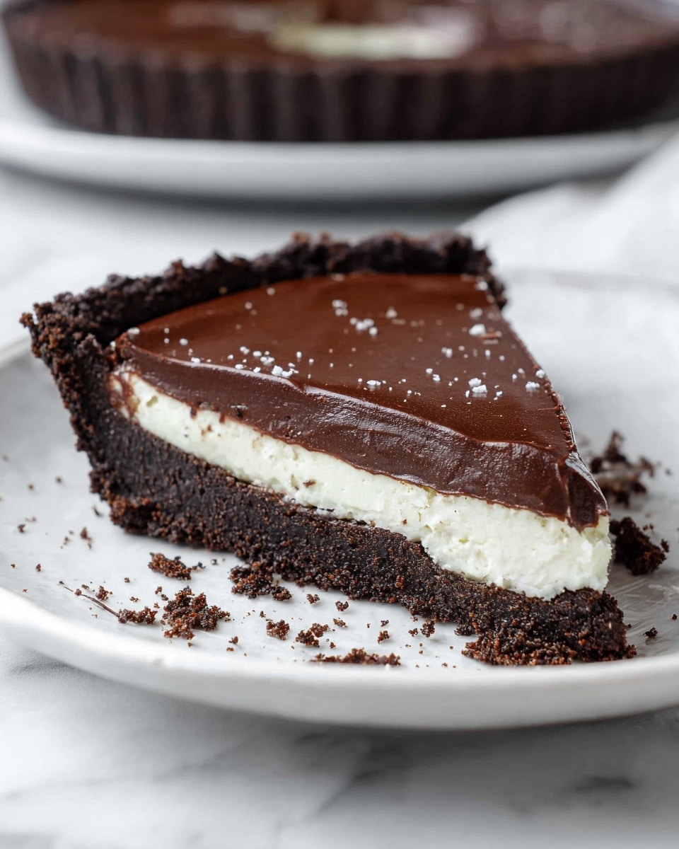 Whole Oreo chocolate cream pie on a large white plate, featuring a rich, smooth dark chocolate filling with a shiny surface, encased in a thick, textured Oreo cookie crust, garnished with scattered Oreo cookie crumbs around the edges, presented on a white marble countertop with natural daylight highlighting the glossy chocolate and the crumbly crust, professional food styling photo taken with an iphone --ar 4:5 --v 7