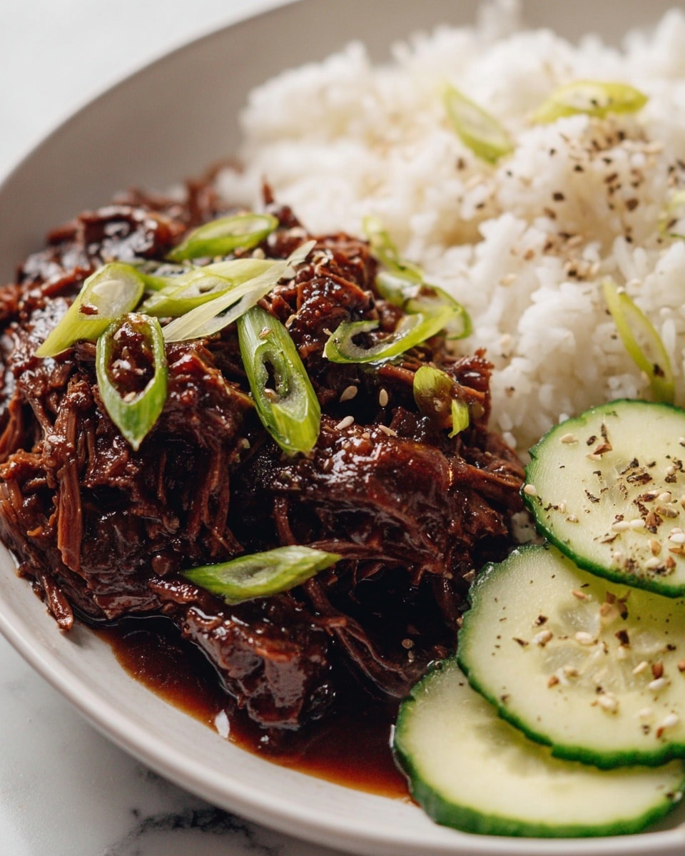 Large white oval serving dish filled with the complete portion of tender, slow-cooked beef brisket in a rich, glossy dark sauce, garnished with freshly sliced green onions scattered on top, the meat beautifully shredded and coated evenly with the savory glaze, photographed from a close 3/4 angle on a white marble countertop with natural lighting, styled as a hero food magazine shot, photo taken with an iphone --ar 4:5 --v 7