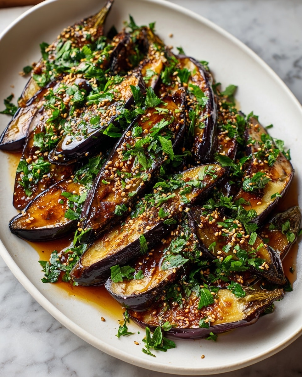 Large white serving platter filled with whole roasted eggplants sliced lengthwise, glistening with a rich glaze of soy and sesame oil, generously sprinkled with fresh chopped parsley and toasted sesame seeds, arranged neatly in overlapping layers showcasing the glossy, caramelized skins and tender flesh, photographed from a 3/4 angle on a white marble countertop with natural lighting, professional food styling photo taken with an iphone --ar 4:5 --v 7
