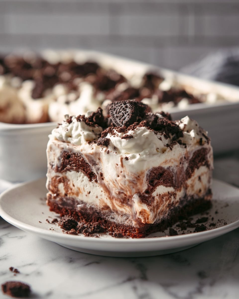 Whole, uncut chocolate brownie ice cream cake in a large white baking dish, layered with rich chocolate brownie base, creamy swirls of vanilla and chocolate ice cream with specks of chocolate bits throughout, generously topped with whipped cream and sprinkled with crumbled chocolate cookie pieces and chunks, presented on a white marble countertop under natural lighting, professional food magazine style hero shot taken with an iphone --ar 4:5 --v 7