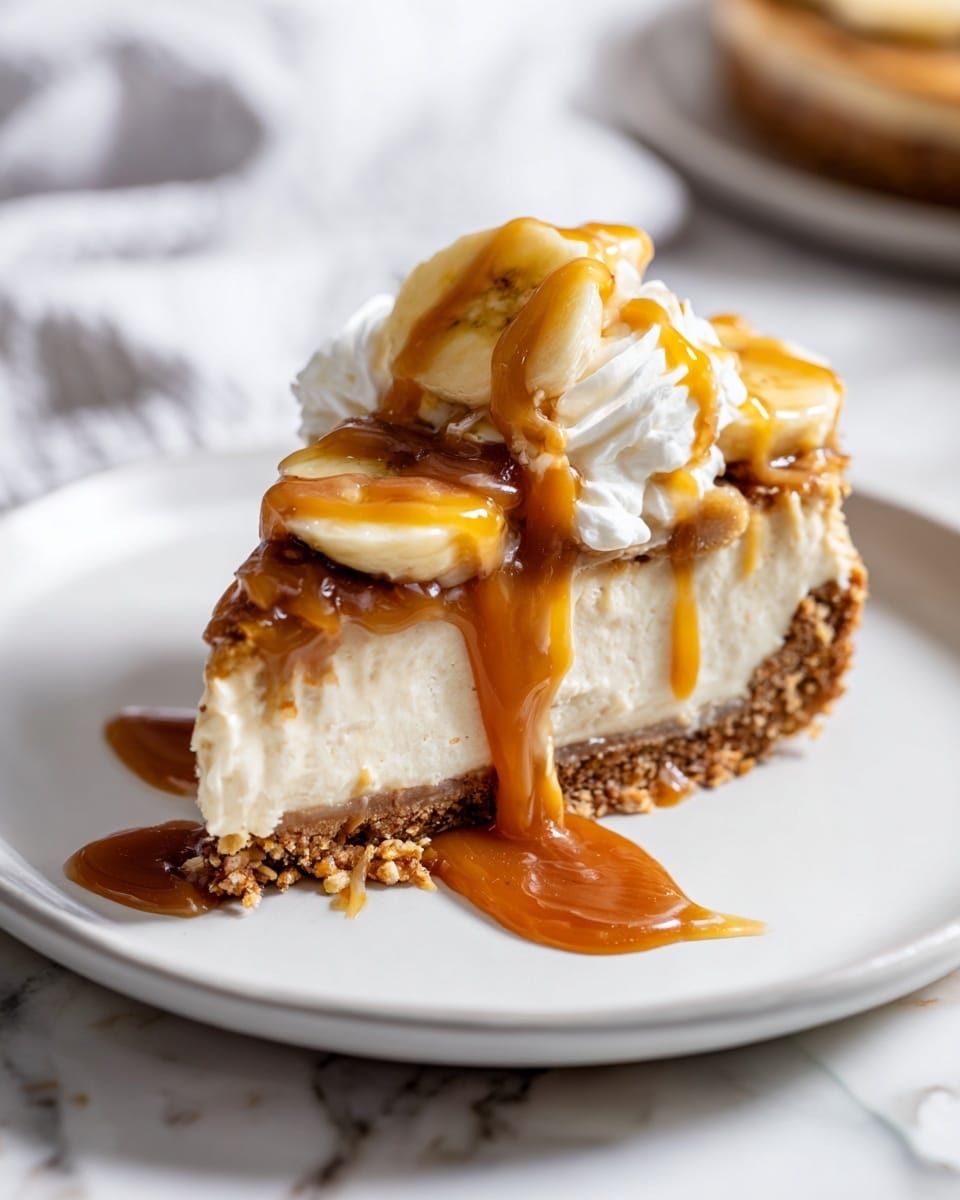 A whole round banana cream pie with a smooth, glossy cream filling topped with evenly spaced fresh banana slices around the entire edge, nestled in a thick, textured golden-brown crust set on a piece of parchment paper over a wooden serving board, the entire pie shown uncut, captured from a 3/4 angle with natural lighting on a white marble background, styled as an elegant hero shot from a food magazine, photo taken with an iphone --ar 4:5 --v 7
